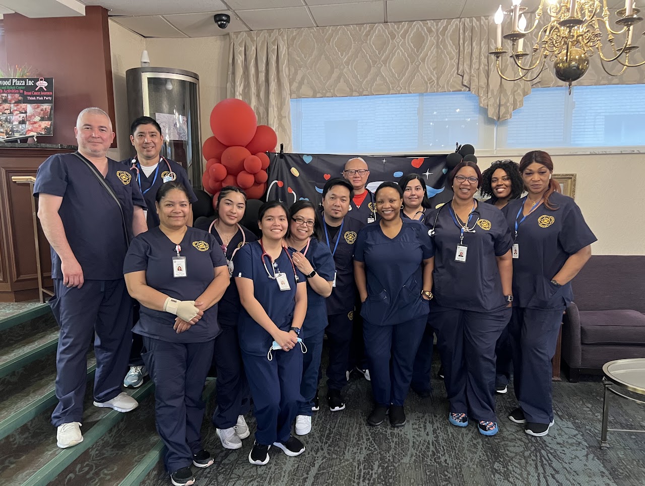 Americare nursing students gathered in navy scrubs